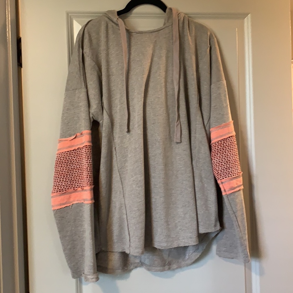 Gray hooded pullover with peach sleeve details